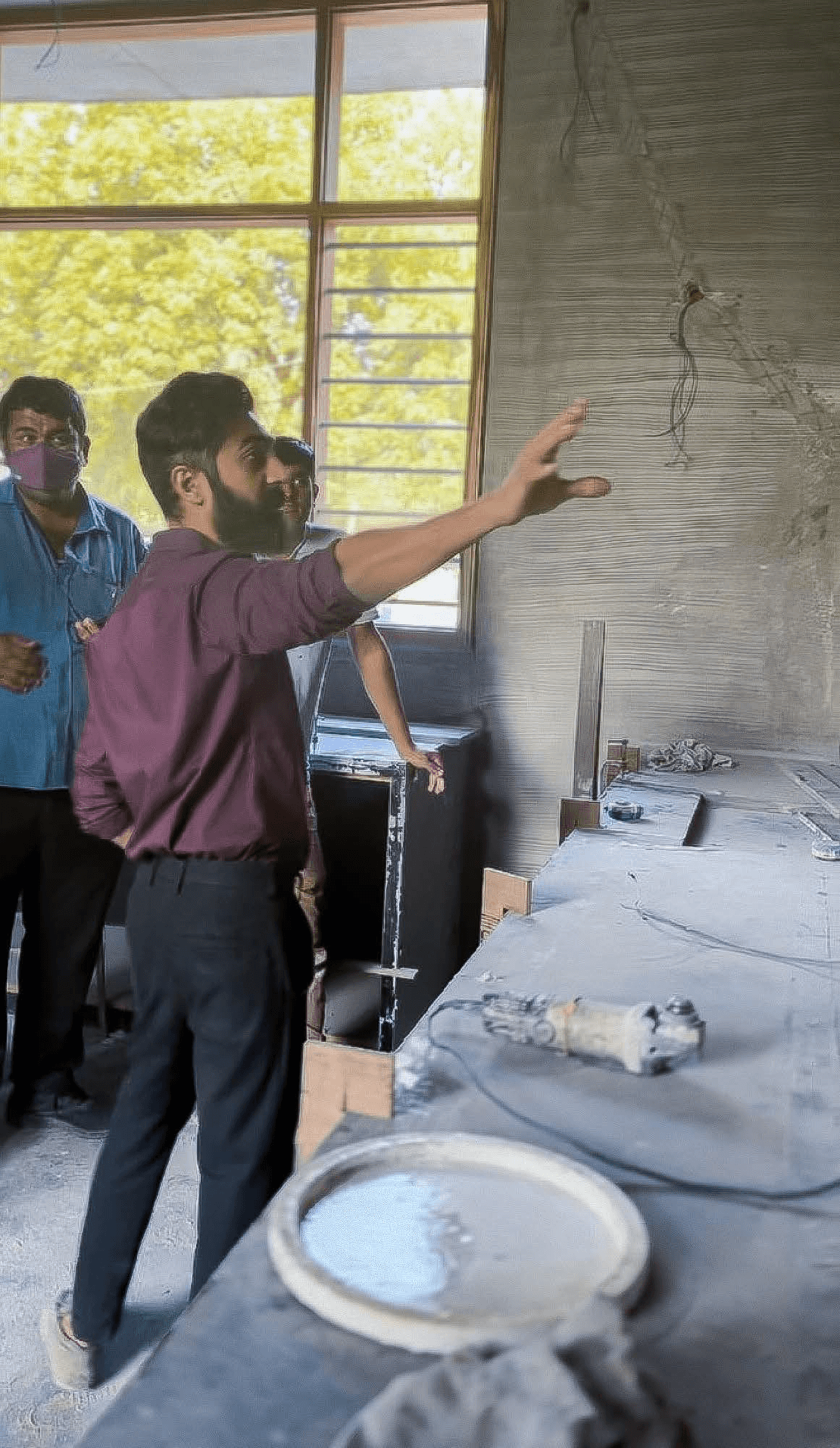Darshan briefing site team — wall finish and framing discussion