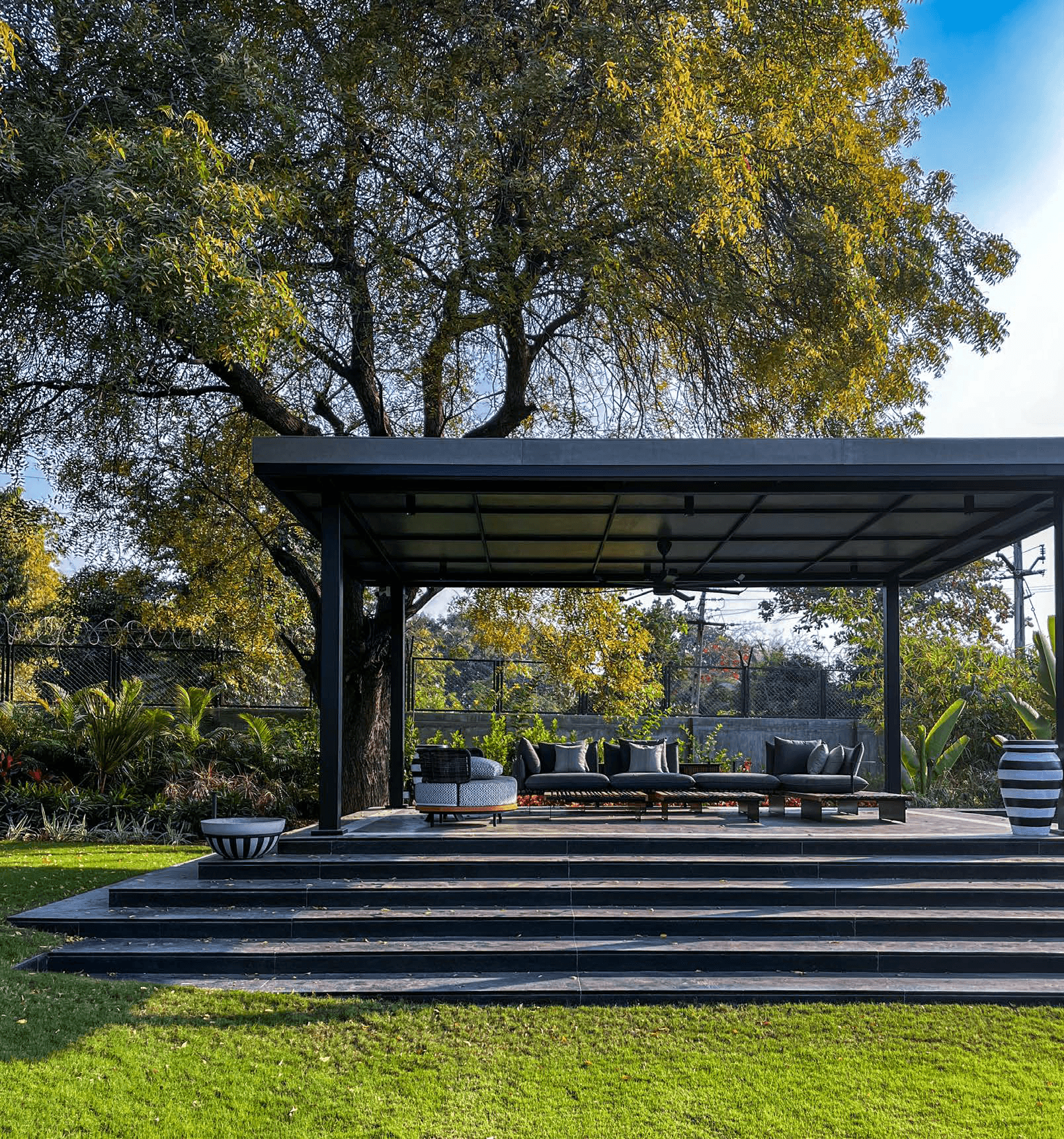 Atelier Reverie — outdoor pavilion with black steel canopy, luxury villa, Ahmedabad